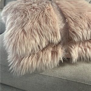 Two pink furry square pillows